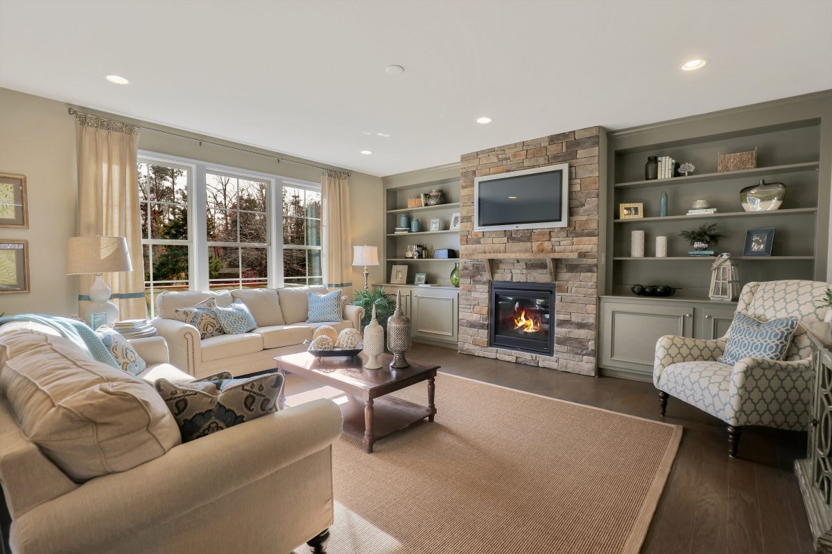 Hillcrest plan living room in cream with stone fireplace, built ins, & hardwood floors in Holloway Estates, Henrico, VA