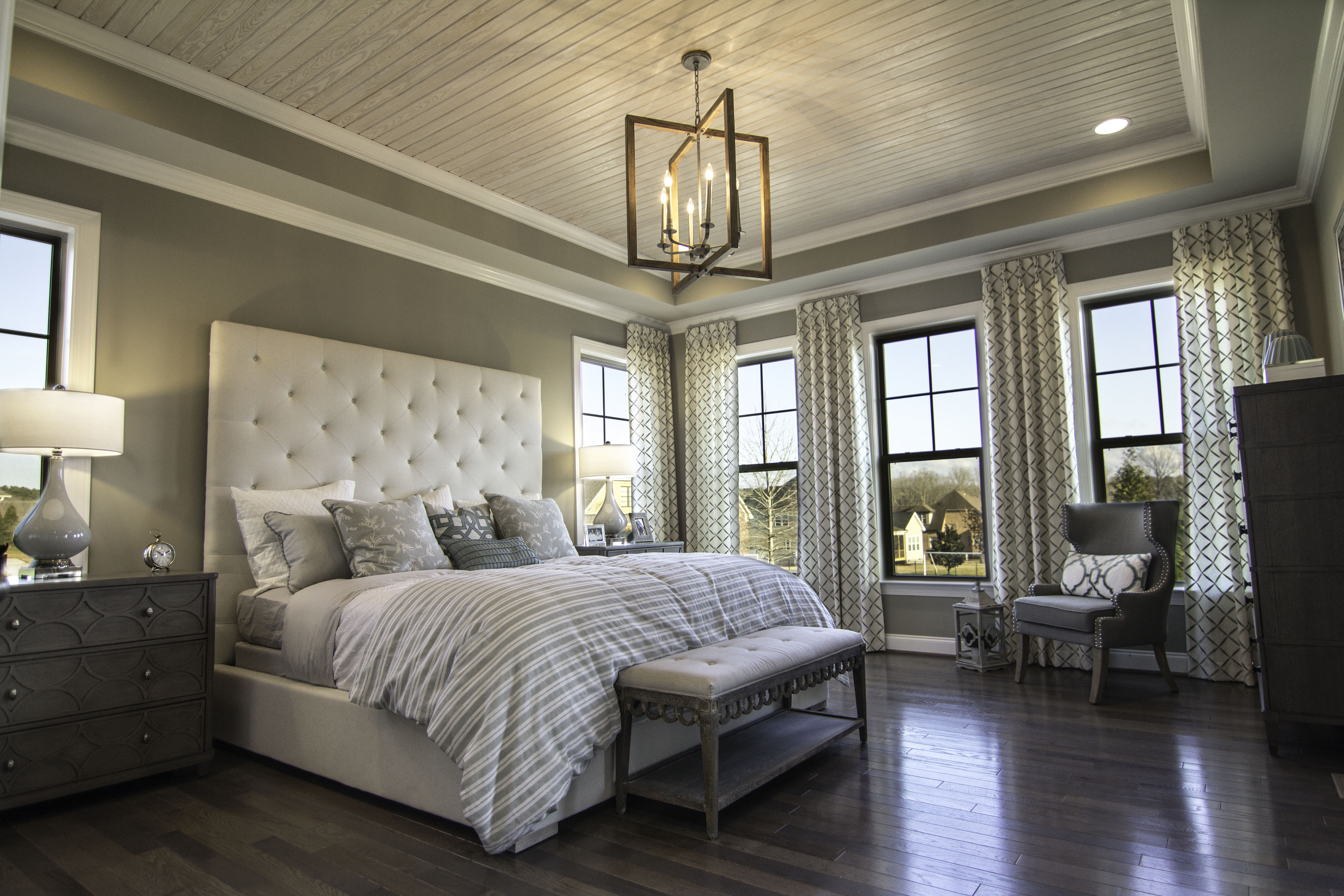 Tray Ceilings and hardwood floors adorn this Owner's Bedroom in the Crawford plan at Banks Pointe.