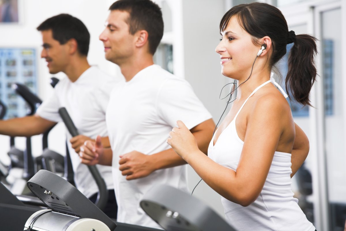 People exercising on cardio machines at a fitness center