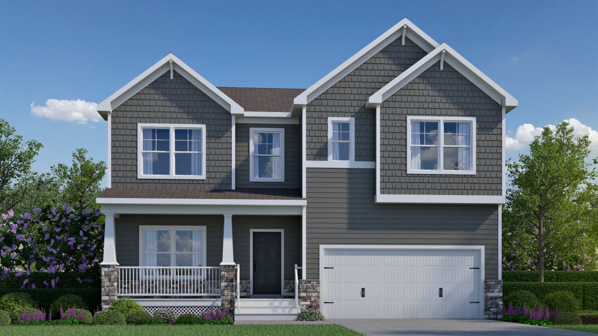 Exterior of the Curie floor plan, Craftsman elevation, by HHHunt Homes at Qualla Trace, featuring dark gray siding with white trim, shake accents on upper gables, a covered front porch with tapered columns and stone bases, and a two-car garage with carria