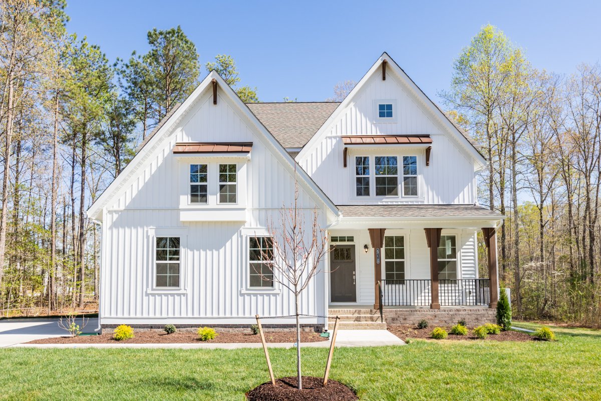 The Chatham floor plan, Farmhouse A elevation by HHHunt Homes at Mount Hermon, featuring a white board-and-batten exterior, covered front porch, and gabled roofline.