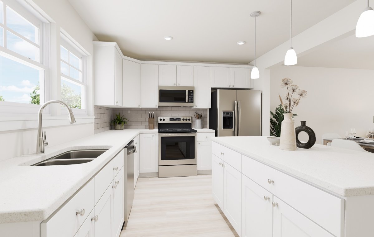 Kitchen in the Amherst floor plan by HHHunt Homes at Edgebrook, featuring white cabinetry, island workspace, stainless steel appliances, pendant lighting, and an open layout.