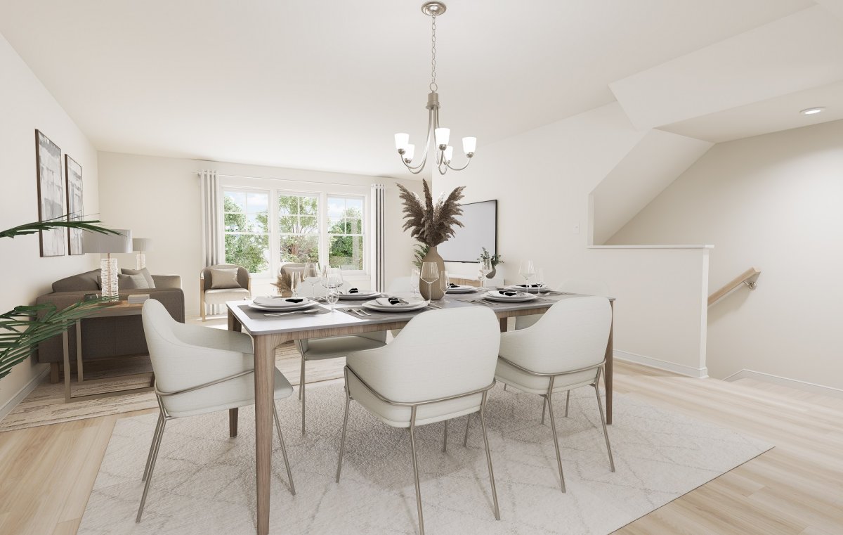Dining area in the Amherst floor plan at Edgebrook by HHHunt Homes, featuring a dining table with seating, chandelier lighting, neutral finishes, and adjacent living space with large windows.
