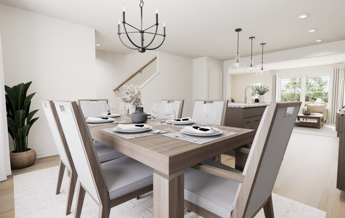 Dining area in the Haywood floor plan at Edgebrook by HHHunt Homes, featuring a dining table with seating, modern chandelier lighting, and an open layout connecting to the kitchen and living area.